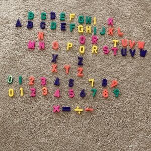 Magnets alphabet and numbers. 67 pieces. Several have double letters. Small